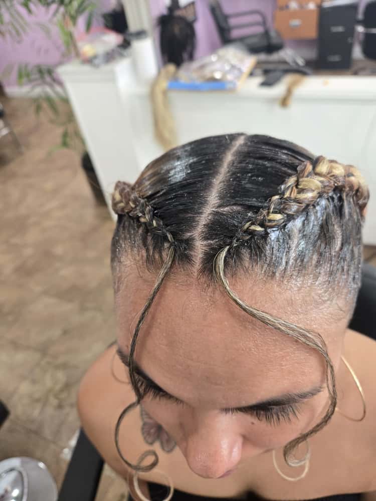 Two-cornrow style by Akwaba Hair Braiding